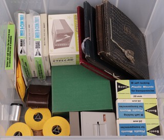 Four black and white photographs albums and a collection of cine films and slides, contained a plastic box 