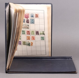 Two blue albums of used world stamps 