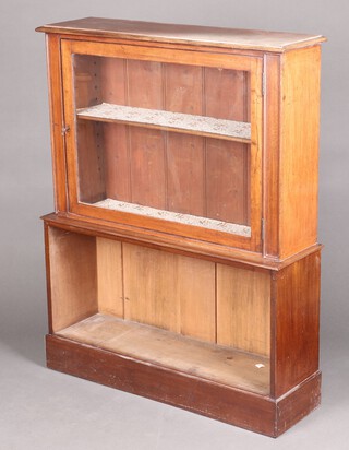 A Victorian mahogany display cabinet on bookcase, the upper section fitted a shelf enclosed by glazed panelled door, the base with recess 123cm h x 97cm w x 28cm d (the bookcase has a plywood top) 