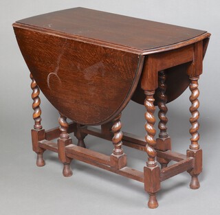 A 1930's oak oval drop flap gate leg dining table, raised on spiral turned supports 72cm h x 88cm w x 42cm d  