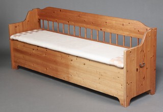 A pine settle with hinged lid and bobbin turned decoration to the back 72cm h x 106cm w x 49cm d 