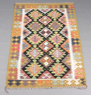 A black, green and orange ground Maimana rug with all over diamond design 57cm x 98cm 