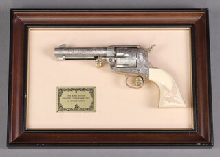 A Franklin Mint "The John Wayne Western Commemorative"  replica Colt 45 single action revolver, contained in a mahogany frame 
