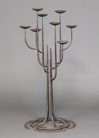 A wrought metal floor standing 8 light candelabrum 113cm h 