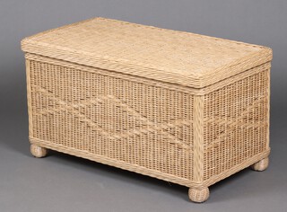 A rectangular rattan ottoman with hinged lid 52cm h x 92cm w x 51cm d 
