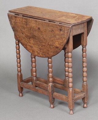 A 17th Century style bleached oak oval drop flap tea table on bobbin turned supports 69cm h x 67cm w x 21cm 