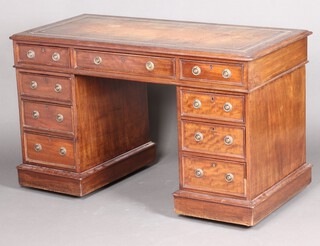 A Victorian mahogany desk with brown inset writing surface above 1 long and 8 short drawers with rug drop handles, 76cm h x 130cm w x 62cm d 
