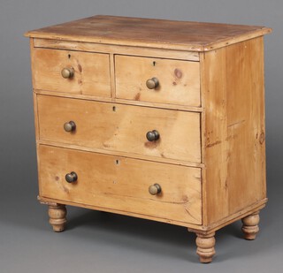 A 19th Century pine chest of 2 short and 2 long drawers with brass handles, raised on turned supports 81cm h x 83cm w x 44cm d 