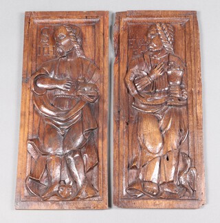 A pair of carved oak panels depicting standing saints 53cm h x 22cm w 