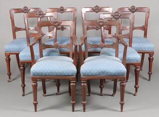 A set of 8 Victorian mahogany bar back dining chairs - 2 carvers, 6 standard, with carved and shaped mid rails and overstuffed seats, raised on turned supports with later plastic casters  