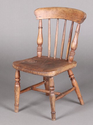A child's 19th Century elm and beech stick and bar back Windsor chair with solid seat, raised on turned supports with H framed stretcher 