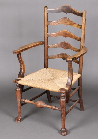 A 17th Century style elm ladder back open arm chair with woven rush seat, raised on club supports with turned stretcher 