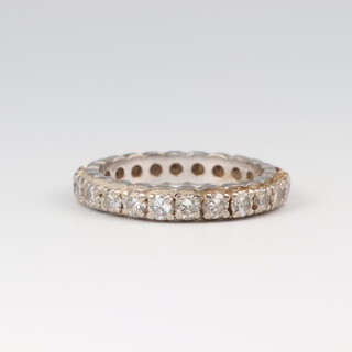 A white gold testing as 18ct diamond set full eternity ring, size O 1/2