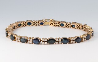 A 14ct gold tennis bracelet, set 19 oval cut sapphires and 24 diamonds, 18cm, 13g 