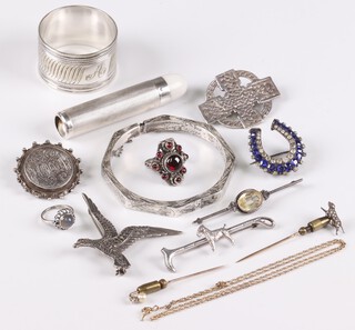 A Sterling silver brooch in the form of a Celtic cross, a silver stock pin decorated an Airedale Terrier, a Victorian engraved silver brooch marked Elizabeth, a small silver cased torch (a/f), a marcasite bracelet, napkin ring, 925 gold plated chain (a/f), 2 stick pins and a collection of costume jewellery