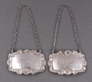 Two embossed silver decanter labels - Brandy, Birmingham 1954 and  Whisky Sheffield 1980 26g 