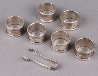 Of shipping interest, 6 Elkington White Star Line silver plated napkin rings numbered 14, 38, 40, 46, 237 and 276, together with a pair of silver plated sugar tongs 