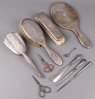 A 3 piece matched silver backed dressing table set with hand mirror Birmingham 1933, hair brush Birmingham 1910 and clothes brush Birmingham 1942 together with a silver backed hand mirror, silver handled button hook, paper knife and button hook 
