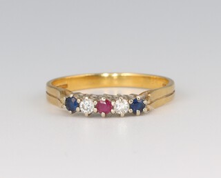 A gold marked 750, diamond, sapphire and ruby set ring, size M, 2.1g 