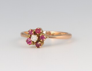 A 9ct gold ring of daisy form set ruby and diamonds, size M, 2g 