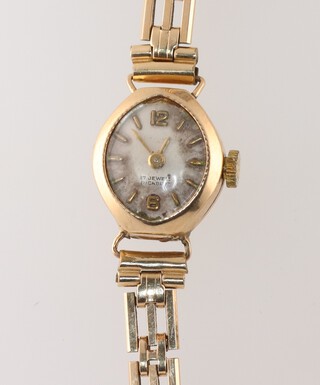 A lady's Incabloc wristwatch with silvered dial, Arabic numerals and batons, movement marked 17 jewels Swiss, contained in a 9ct gold case with rolled gold bracelet 