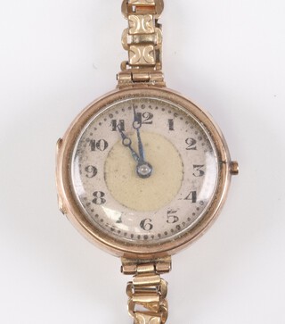 A lady's Cyma wristwatch with silvered dial and Arabic numerals in a 9ct gold case, on a gilt metal strap 