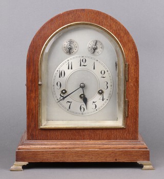 The Junghans Clock Company, a chiming bracket clock with 15cm arched silvered dial, silvered chapter ring, Arabic numerals, slow/fast and strike/chime indicators, the back plate marked B20, striking on 5 gongs, contained in an arch shaped oak case 35cm h x 30cm w x 22cm d 