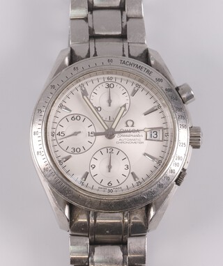 A gentleman's Omega Speedmaster automatic chronometer wristwatch with silvered dial, 3 subsidiary dials and calendar aperture, contained in a chrome case with integral bracelet, together with operating instructions, chronometer certificate card, International Warranty card and Pictograms card, box and outer box  