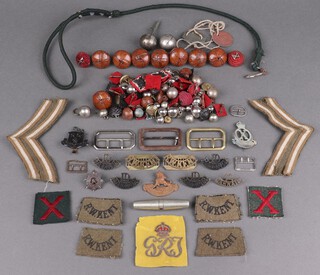 A 10th Baluch Regiment cap badge, ditto shoulder title, British South Africa police cap badge (a/f), a Cranbrook School OTC cap badge, various buttons, pips etc 