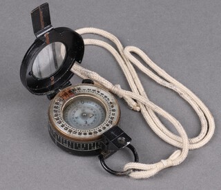 A Second World War military prismatic compass marked T.G. Co. Ltd London 1914 Mk3 with lanyard 
