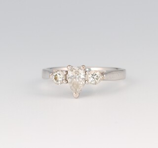 An 18ct white gold ring, set a heart shaped diamond supported by 2 diamonds, size M, 3.5g