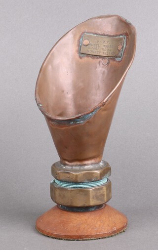 A 19th/20th Century copper and brass Naval voice pipe mouth piece marked V-P7 Wheelhouse Chartroom Monkey Island, raised on a turned socle base.  (NB. The island is a traditional nautical term referring to the highest accessible deck on a ship, located directly above the bridge or wheelhouse)