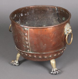 A 19th Century circular copper log bin with brass iron drop handles and gilt paw feet 39cm h x 45cm diam. 