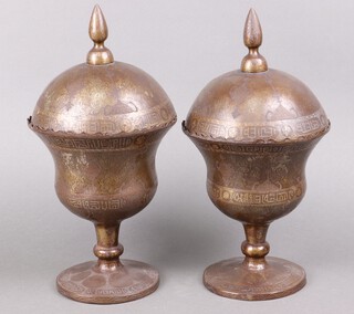 A pair of Eastern engraved metal urns and covers decorated figures and with script 44cm 
