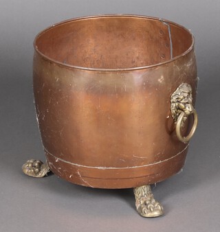 A copper and brass twin handled log bin with swing handle, raised on paw feet 33cm h  