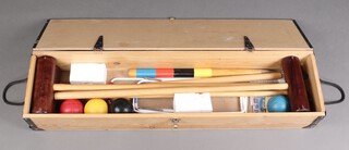 A Townsend Croquet Limited standard croquet set comprising 4 mallets, 4 balls, 6 hoops and a peg, contained in a wooden box  