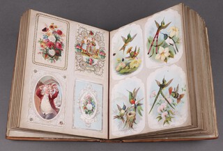 A large Victorian leather bound album comprising mainly Victorian Christmas and new year cards, the front and rear panels ornately tooled floral motifs, 4to.  