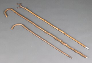 A wooden crook, a stag horn mounted walking stick and 1 other stick 