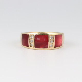 An 18ct gold ring set 2 rows each of 3 diamonds, interspaced by 3 rectangular red stones, size M 1/2, 6g 
