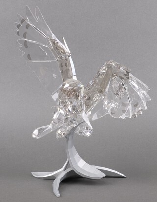 A Swarovski Crystal 2015 Secret Guardian figure - Snowy Owl with wings outstretched on a stylised matt silvered stand  29cm, boxed and with certificate 