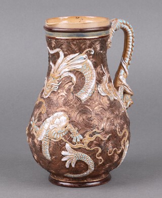 A Doulton Lambeth salt glazed jug decorated dragons and with dragon mask handle, the base impressed Doulton Lambeth and incised A 19cm 