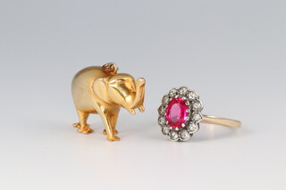 A gold testing as 14ct charm in the form of an elephant, made from a wedding ring, 4.2g together with a 9ct gold and silver paste set ring size M 1/2