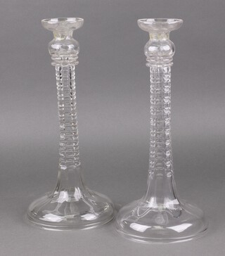 A pair of hollow glass candlesticks/table lamps on spreading bases 38cm, the base with aperture for flex  