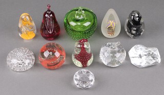 A green bubble glass paperweight in the form of an apple 10cm, a clear glass ditto, 2 paperweights in the form of pears and 7 others 