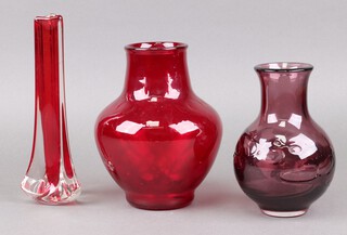 A Whitefriars red tricorn vase 23cm, a Whitefriars purple glass club shaped vase 18cm and a red ditto 21cm 