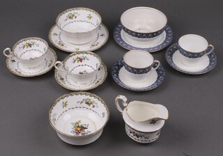 An Aynsley 43 piece tea service decorated grapes, pears and apples, reverse marked A411W comprising 2 twin handled bread plates (1 rings flat), 12 tea plates (1 cracked, 1 rings flat), 2 sugar bowls (1 rings flat), cream jug, 13 cups, 13 saucers (2 cracked, 4 ring flat), together with an Aynsley 39 piece Daffodil pattern tea set A4618 16 comprising 2 twin handled bread plates (1 cracked), 12 tea plates (2 cracked and repaired), 8 cups (5 with visible cracks, all ring flat), 9 saucers (3 ring flat, 1 with chip)  