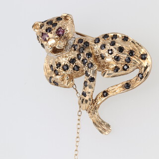 A gold and gem set brooch in the form of a leopard, 10g