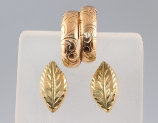A pair of gold testing as 9ct leaf shaped earrings and a pair of 9ct gold hoop earrings, 2.9g