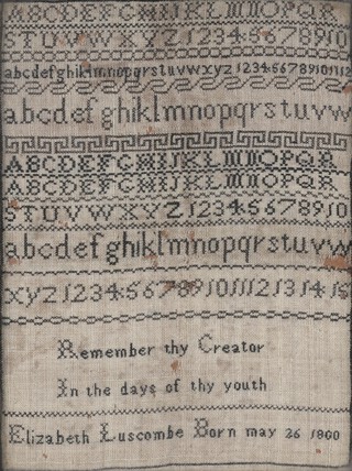 A sampler by Elizabeth Luscombe of Combe Royal, Devon, with letters of the alphabet and numbers in horizontal formation, above a panel of text, 'remember thy creator in the days of thy youth, Elizabeth Luscombe born May 26 1800'.