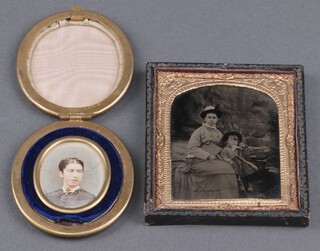 A 19th century daguerreotype portrait of a Lady with a Child, 7cm x 5.5cm, within a gilt repousse metal and leather frame, together with a late 19th century miniature portrait of a Lady, watercolour on paper, 4cm x 3.5cm, within a gilt frame.